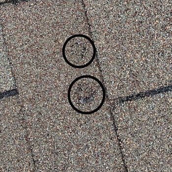 Roof tiles with hail damage circled