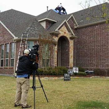 Roof repairs being recorded by news station after a hailstorm