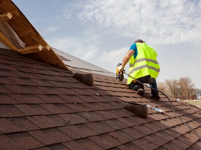 man using power tools to repair the top of a roof