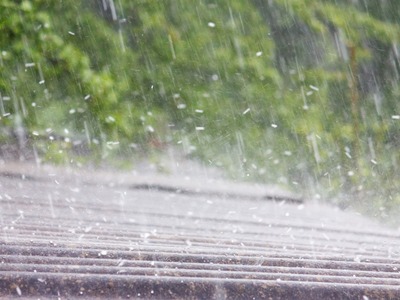 rain falling on the top of a roof with green background
