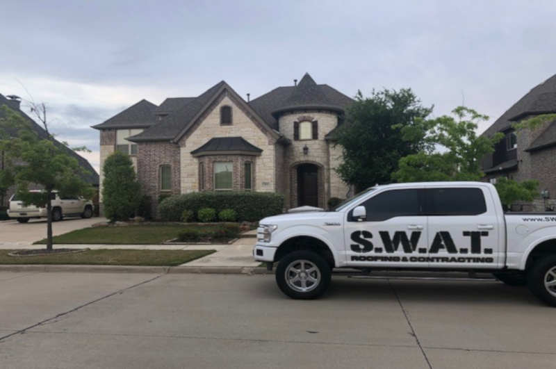 SWAT roofing truck parked in front of a residential house