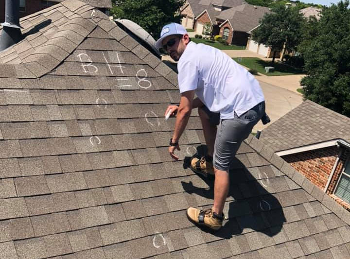 roofing contractor inspecting hail roof damage